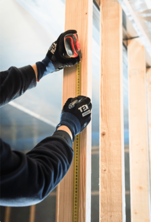 A man measuring a wood